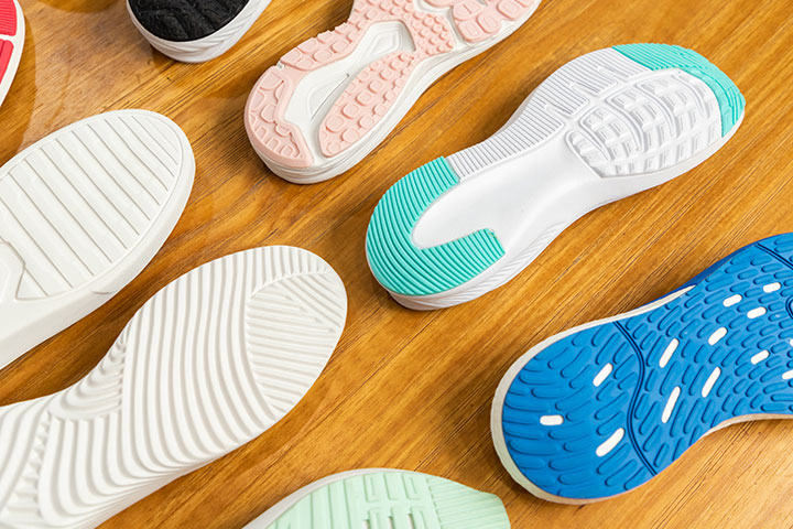 A variety of patterns of soles on the table for display.