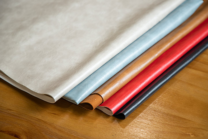 Many different colors of PU leather are placed on the table.